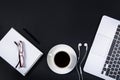 Black office desk with laptop, notebook, , glasses and cup of coffee. Royalty Free Stock Photo