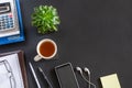 Black office desk with notebook, calculator, diary and smartphone with headphones. Top view with copy space, flat lay Royalty Free Stock Photo