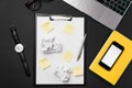 Black office desktop with white sheet of paper with free copy space and pen, laptop, glasses, watch and crumpled paper Royalty Free Stock Photo