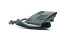 Black office phone with handset in foreground Royalty Free Stock Photo