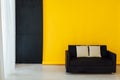 Black office sofa in the yellow office interer Royalty Free Stock Photo