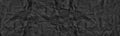 Black old crumpled paper wide panoramic texture. Wrinkled dark paper sheet large banner vintage grunge background Royalty Free Stock Photo