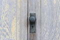 Black old door knob on wooden doors, vintage style.