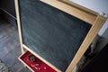 Black old empty chalkboard for copy space with colorful pieces of chalk. Royalty Free Stock Photo