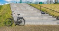 Black old ladies bike next to a concrete staircase Royalty Free Stock Photo