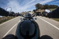 Black old motorbike travelling on a tarmac road driver point of view beautiful landscape