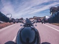 Black old motorbike travelling on a tarmac road driver point of view