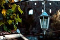 Black old vintage lamp on brick wall with decorative candles inside at old town house. Royalty Free Stock Photo
