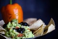 Black Olive Spiders and Sick Bell Pepper Jack O Lantern With Guacamole Royalty Free Stock Photo