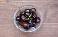 Black olives on bowl on wood from above Royalty Free Stock Photo