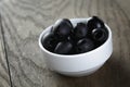 Black olives from can in bowl on table Royalty Free Stock Photo