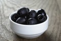 Black olives from can in bowl on table Royalty Free Stock Photo