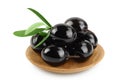 Black olives with leaves in wooden bowl isolated on a white background with full depth of field. Royalty Free Stock Photo