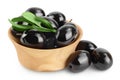 Black olives with leaves in wooden bowl isolated on a white background with full depth of field. Royalty Free Stock Photo