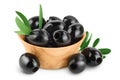 Black olives with leaves in wooden bowl isolated on a white background with full depth of field. Royalty Free Stock Photo