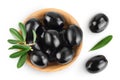 Black olives with leaves in wooden bowl isolated on a white background with full depth of field. Top view. Flat lay Royalty Free Stock Photo