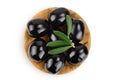 Black olives with leaves in wooden bowl isolated on a white background with full depth of field. Top view. Flat lay Royalty Free Stock Photo