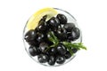 Black olives with lemon in a glass bowl. Top view. Isolated over white background Royalty Free Stock Photo