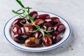 Black olives with olive oil and rosemary branch on a plate Royalty Free Stock Photo