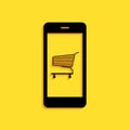 Black Online shopping concept. Shopping cart on screen smartphone icon isolated on yellow background. Concept e-commerce