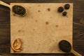 Black, Oolong in a spoon, dried apples on the old blank open book on wooden background. Menu, recipe Royalty Free Stock Photo