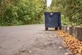 Open trash can on the road Royalty Free Stock Photo