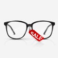 Black optical glasses on white background.