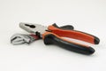 Black and orange adjustable spanner tools and tongs on a white background Royalty Free Stock Photo