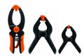 Black and orange spring clamp isolated on white background. Set of small, medium, and big size of plastic clamp. Clamping tools Royalty Free Stock Photo