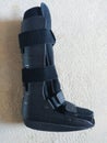 A black Orthopedic or medical boot, cast or footwear