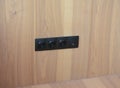 Black outlet plug on the modern wooden wall. Socket, european power, internet plug Royalty Free Stock Photo