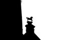 Black outline silhouette of building and horse on white background