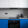 Black oven and induction hob in minimalist kitchen, close-up Royalty Free Stock Photo