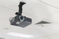 A black overhead projector on ceiling indoors. Royalty Free Stock Photo