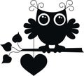 A black owl with a big heart Royalty Free Stock Photo