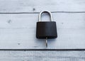Black padlock on a white wooden background. The concept of security. Royalty Free Stock Photo