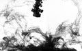 Black paint swirling in water Royalty Free Stock Photo