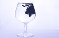 Black paint in water in a crystal glass on a white background Royalty Free Stock Photo