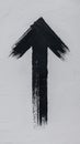 Black Painted Arrow Pointing Upwards on White Textured Wall Surface Royalty Free Stock Photo
