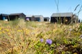 Black painted wooden fishermens` huts in the sand dunes at Winterton on Sea near Great Yarmouth of the east coast of Norfolk UK. Royalty Free Stock Photo