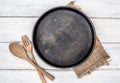 Black pan board and a tablecloth with wooden fork and spoon on white table , recipes food  for healthy habits shot note background Royalty Free Stock Photo