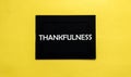 Black pancel write a text Thankfulness on the yellow