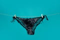 Black panties on rope. Sexy lingerie. Lace underwear. Womans black erotic panties. Womens panties hanging isolated on Royalty Free Stock Photo
