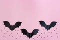 Black paper bats flying over pink colored background. Halloween and decoration concept Royalty Free Stock Photo