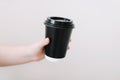 Black paper cup of coffee take away. Disposable cup on a white background. Place for text. Royalty Free Stock Photo