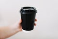 Black paper cup of coffee take away. Disposable cup on a white background. Place for text. Royalty Free Stock Photo