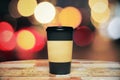 Black paper cup of coffee to go on the wooden table Royalty Free Stock Photo