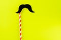 Black paper mustache with copy space for text on yellow background.