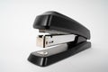 Black paper stapler on a white background Royalty Free Stock Photo