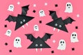 Black paper vampire bats with funny googly eyes and and ghosts and spider shaped confetti on pink Halloween background